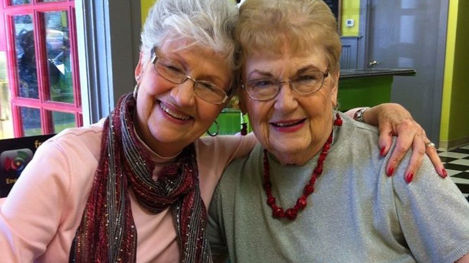 two old ladies smiling at camera