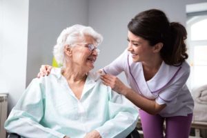 an elderly woman talks to her nurse about the benefits of long-term skilled nursing care