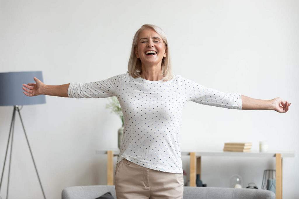 woman arms outstretched understanding the difference between independent living vs assisted living