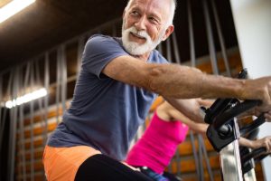 senior man exercising and learning the benefits of physical activity