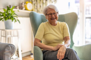 A senior woman enjoys considering the differences between independent living and assisted living.