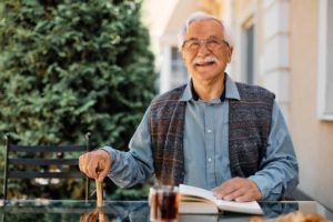 Man sitting and enjoying book after entering assisted living