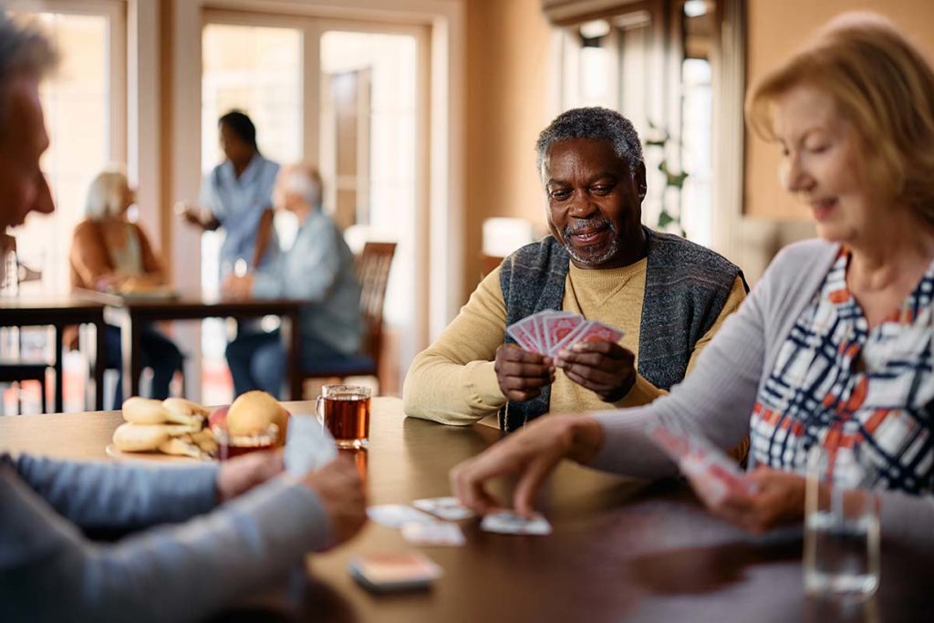 Seniors play cards, one of the activities that most assisted living facilities provide