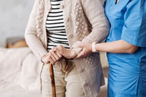 Skill nurse helps resident walk, one of the reasons term skilled nursing matters