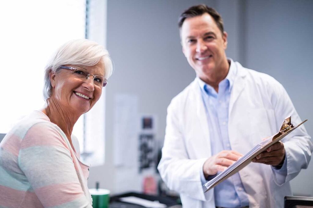 Doctor and patient smile as they discuss the reasons for long term skilled nursing care