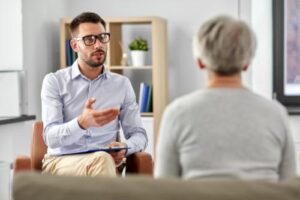 Man talks to senior about senior speech therapy 