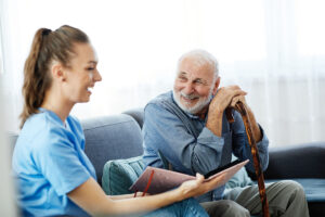 A senior adult man sits next to a team member at Baptist Retirement who explains the cost of memory care to him.