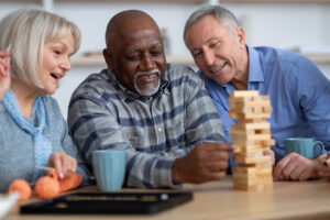 Seniors play game together after learning activities for assisted living seniors