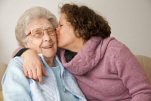 Woman kisses senior as she discovers tips to preventing Alzheimer's