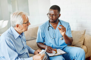 Health professional talks to senior about the importance of medication management