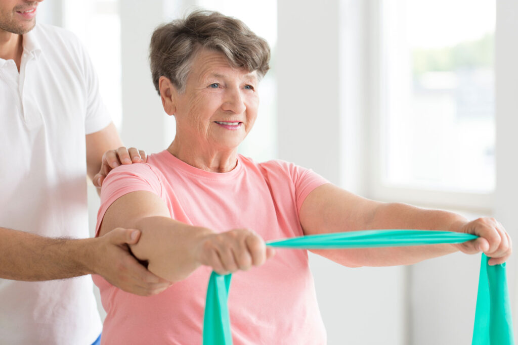 Woman stretches arms while doing exercise in a senior rehab in San Angelo, TX