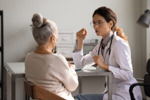 A senior adult woman benefits from speech therapy after a stroke.