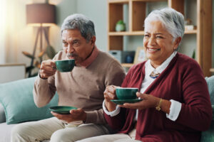 A man and woman enjoy their coffee. They are residents in a senior living community that prioritizes laws and regulations that benefit them.