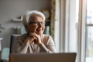 A woman is happy after learning about what to expect during the transition to assisted living.