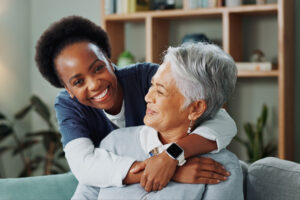 Woman hugs ssenior in personalized care in senior living